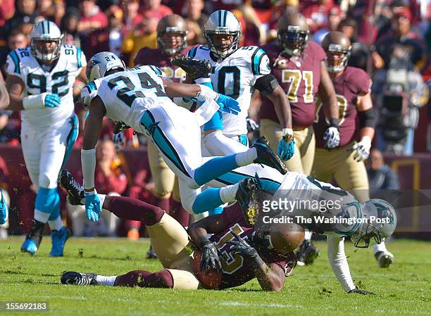 Washington Redskins wide receiver Josh Morgan hits the ground after completing a pass for a first down as Carolina Panthers defensive back Josh...