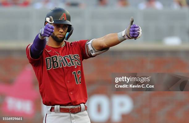 Lourdes Gurriel Jr. #12 of the Arizona Diamondbacks reacts after hitting a two-RBI double in the third inning against the Atlanta Braves at Truist...