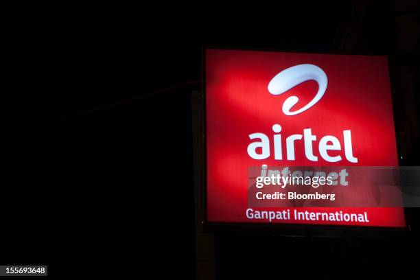 Bharti Airtel Ltd. Sign for internet services is displayed outside a mobile services store in New Delhi, India, on Tuesday, Nov. 6, 2012. Bharti...