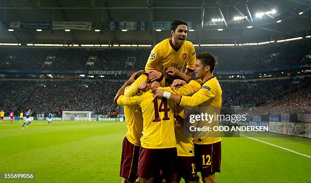 Arsenal´s Spanish midfielder Mikel Arteta and teammates celebrate Theo Walcott putting their team 1-0 up during the UEFA Champions league group B...