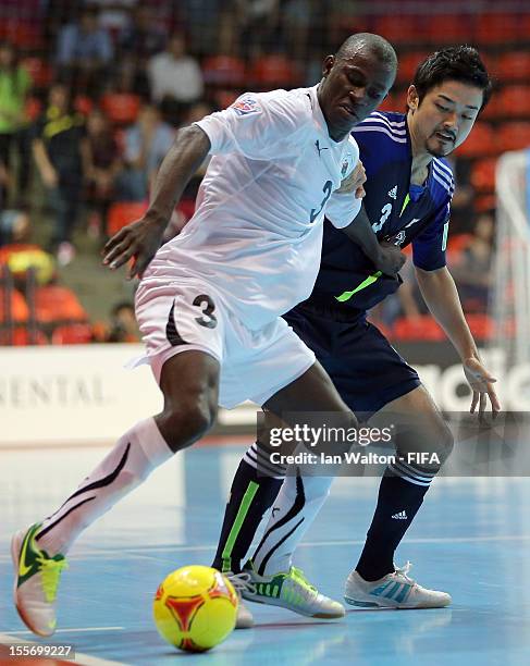 Bader Hasan of Libya tries to tackle Wataru Kitahara of Japan during the FIFA Futsal World Cup Group C match between Japan and Libya at Indoor...