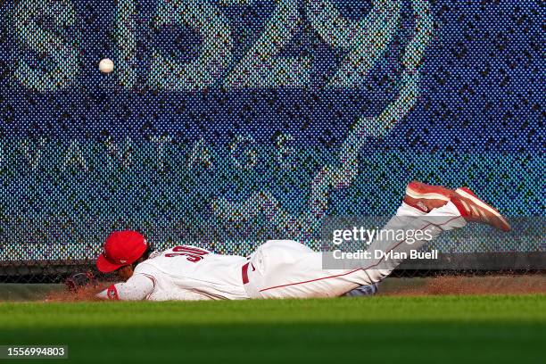 Will Benson of the Cincinnati Reds dives in an attempt to catch a double hit by Luis Matos of the San Francisco Giants in the second inning at Great...