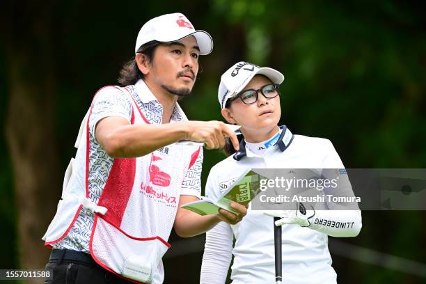 Sakura Yokomine of Japan talks with her caddie and husband Yotaro Morikawa on the 3rd tee during the first round of DAITO KENTAKU eheyanet Ladies at...