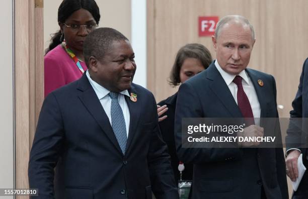 This pool image distributed by Sputnik agency shows Russian President Vladimir Putin meeting his Mozambique counterpart Filipe Jacinto Nyusi during...