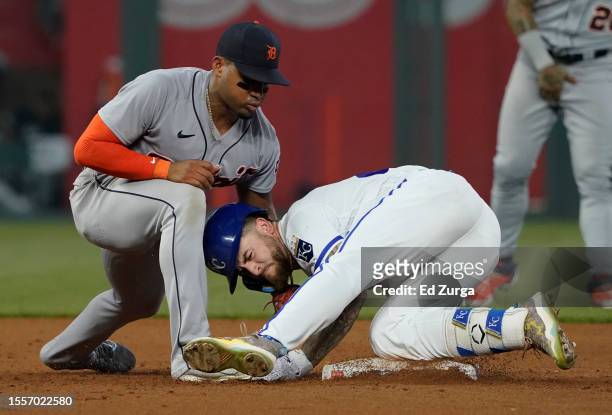Kyle Isbel of the Kansas City Royals slides into second past Andy Ibanez of the Detroit Tigers for an RBI double in the fifth inning at Kauffman...