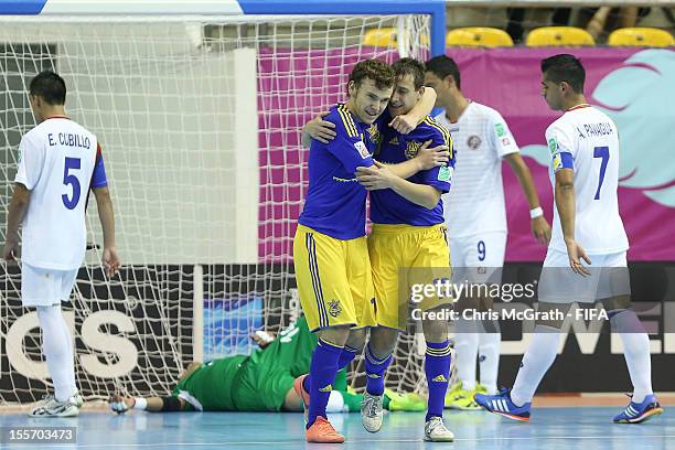 Petro Shoturma of Ukraine congratulates team mate Oleksandr Sorokin after he scored a goal against Costa Rica during the FIFA Futsal World Cup, Group...