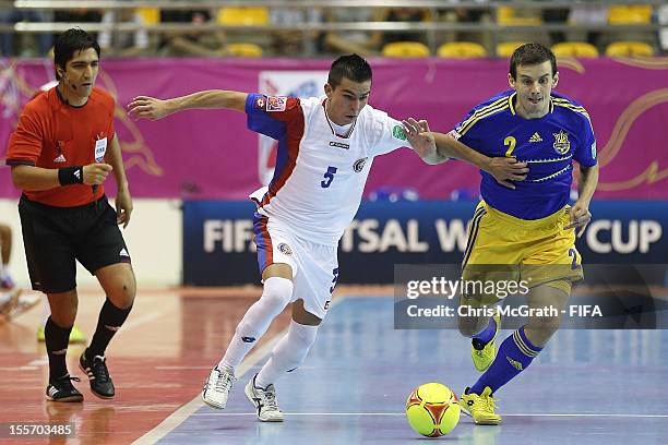 Edwin Cubillo of Costa Rica fends off Mykhaylo Romanov of Ukraine during the FIFA Futsal World Cup, Group A match between Costa Rica and Ukraine at...