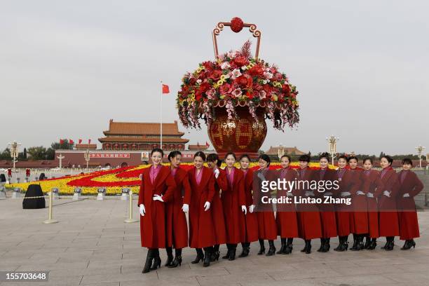 Attendants pose for a picture during at the Tiananmen Square on November 7, 2012 in Beijing, China. The18th National Congress of the Communist Party...