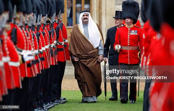 Britain's Prince Philip , and Qatar's emir, Sheikh Hamad bin Khalifa al-Thani , review a Guard of Honour in the quadrangle at Windsor Castle in...