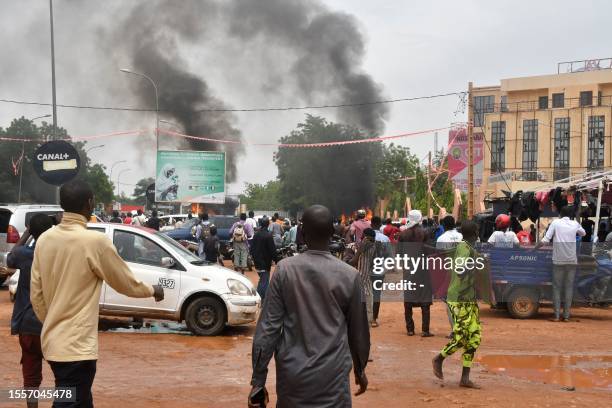 General view of billowing smoke as supporters of the Nigerien defence and security forces attack the headquarters of the Nigerien Party for Democracy...