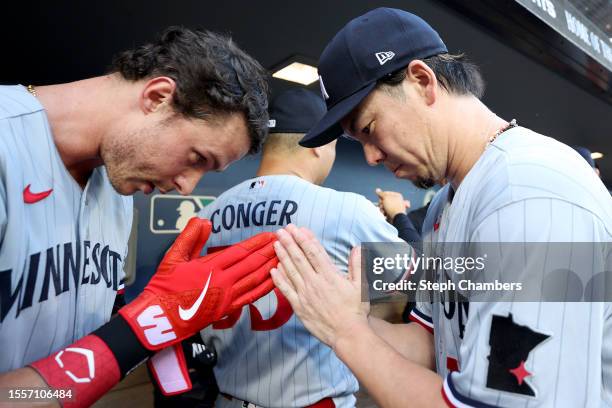 Max Kepler and Kenta Maeda of the Minnesota Twins bow before the game against the Seattle Mariners at T-Mobile Park on July 19, 2023 in Seattle,...