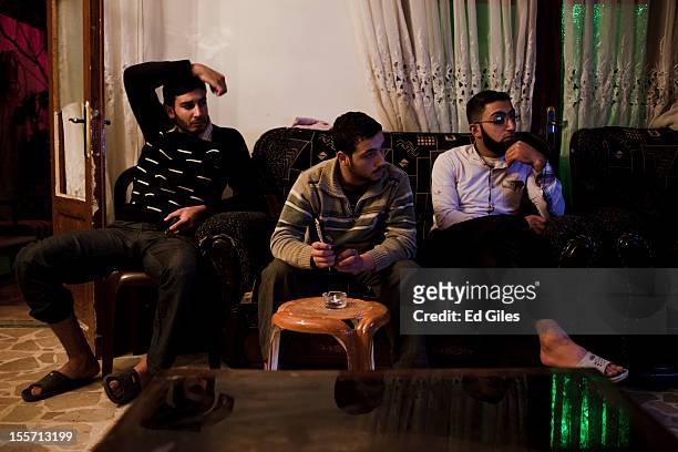 Fighters of the Shohada al Haq brigade of the Free Syrian Army watch television in the brigade's 'home base' near the Salahudeen district on November...