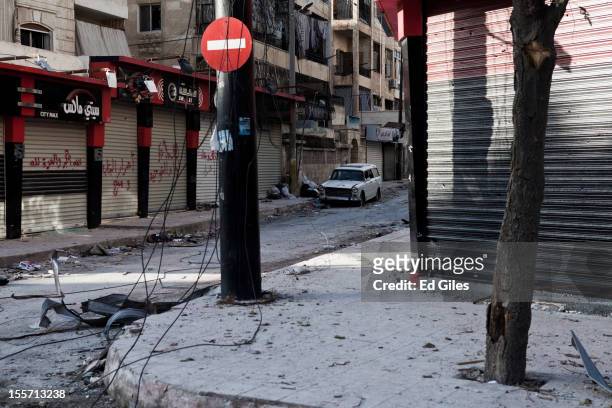 Damaged car sits alone in a 'sniper alley', visible to Syrian military positions, near the Salahudeen district on November 1, 2012 in Aleppo, Syria....