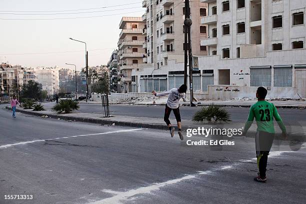 Syrian children play football on a road near the Salahudeen district on November 3, 2012 in Aleppo, Syria. The Shohada al Haq, or 'Martyrs of Truth'...