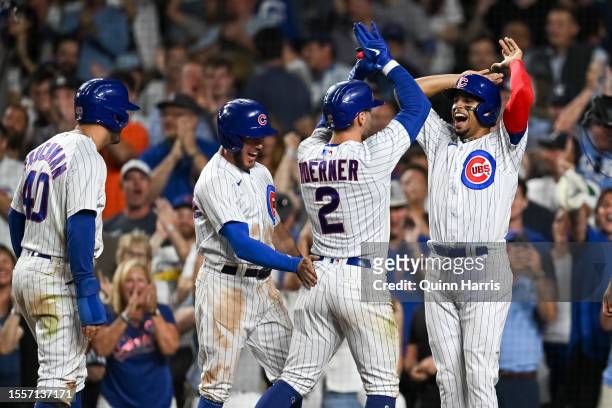 Nico Hoerner of the Chicago Cubs celebrates his grand slam with Mike Tauchman, Miles Mastrobuoni and Christopher Morel in the eighth inning against...