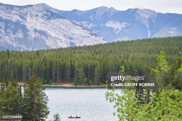 Visitors canoe on Lake Minnewanka in Banff National Park in Banff, Alberta, Canada, on May 23, 2023.