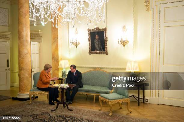 In this photo provided by the German Government Press Office , German Chancellor Angela Merkel and British Prime Minister David Cameron talk during a...