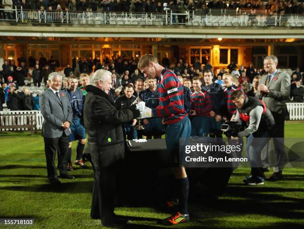 West Ham United Chairman David Gold presents the first ever FA Cup to Royal Engineers AFC Captain Jay Hubbard after winning the First FA Cup Final...