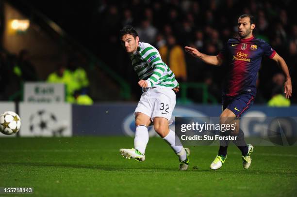 Celtic player Tony Watt scores the second goal watched by Barcelona player Javier Mascherano during the UEFA Champions League Group G match between...