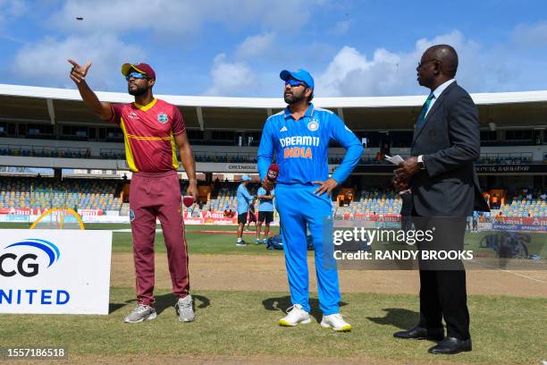 Shai Hope of West Indies tosses the coin as Rohit Sharma of India and match referee Sir Richie Richardson watch st the start of the first One Day...