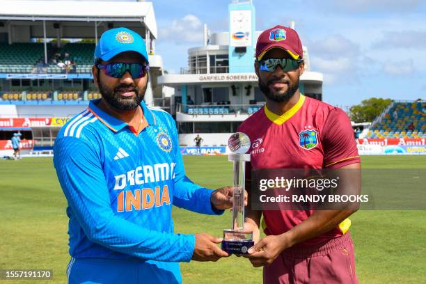 Rohit Sharma of India and Shai Hope of West Indies pose with the ODI trophy at the start of the first One Day International cricket match between...