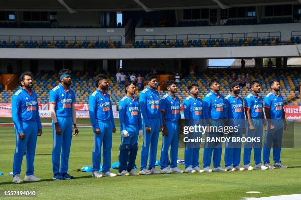 India players stand at attention for the national anthem at the start of the first One Day International cricket match between West Indies and India,...