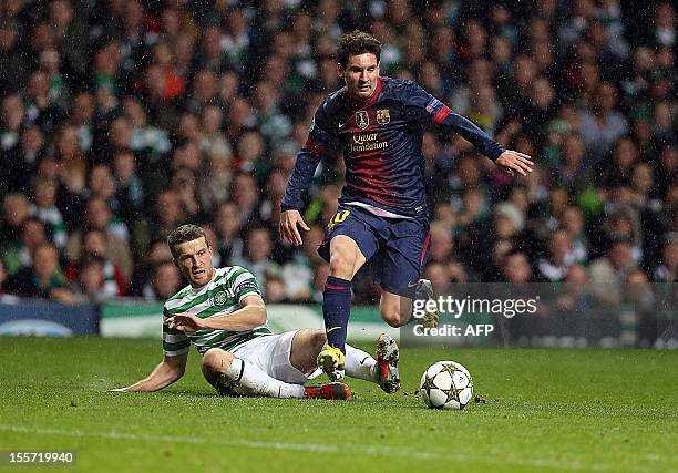 Barcelona's Argentinan striker Lionel Messi competes with Celtic's Welsh defender Adam Mathews during their UEFA Champions League Group G football...