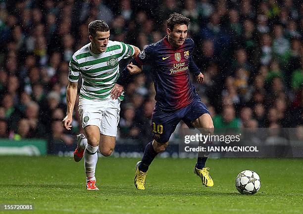 Celtic's Welsh defender Adam Mathews competes with Barcelona's Argentinian striker Lionel Messi during their UEFA Champions League Group G football...