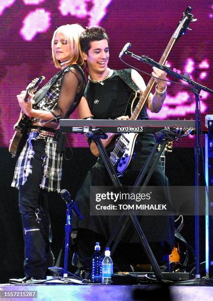 Singer Madonna , playing guitar, jams with her bass player as she performs in the first of two sold-out shows at the First Union Center in...