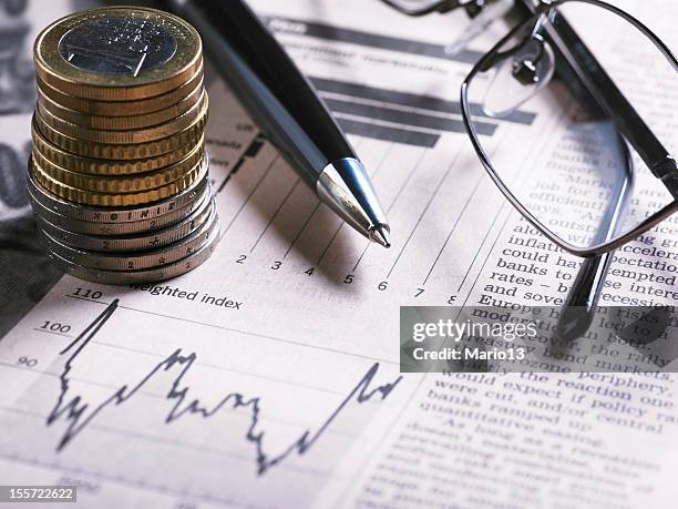 a financial chart with coins, glasses and pen - us paper currency stock pictures, royalty-free photos & images