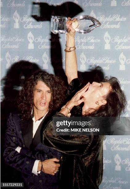 Musicians Steven Tyler and Joe Perry of the rock group Aerosmith have some fun as they pose with the People's Choice Award they won as favorite rock...