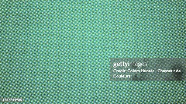 close-up of a green background with yellow dots printed offset on white paper in paris, france - couleurs fond stock-fotos und bilder