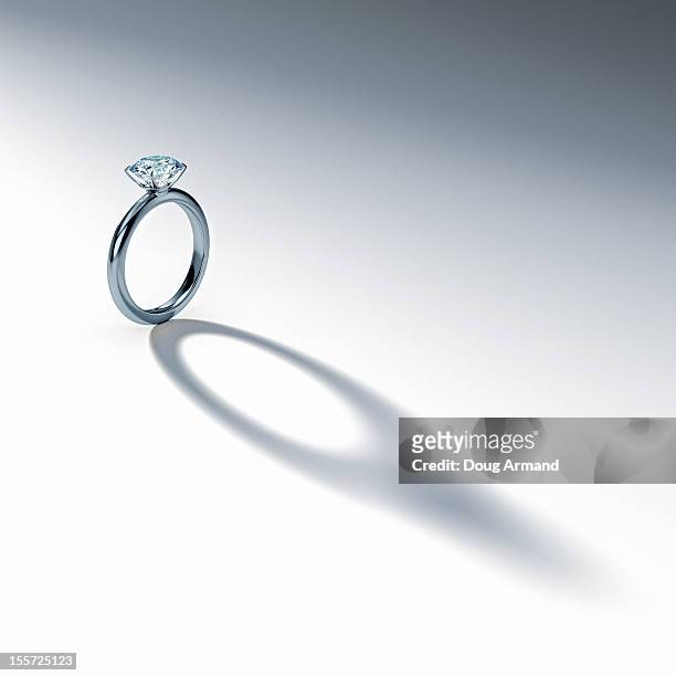 silver diamond ring casting shadow on white - engagement ring stock-grafiken, -clipart, -cartoons und -symbole