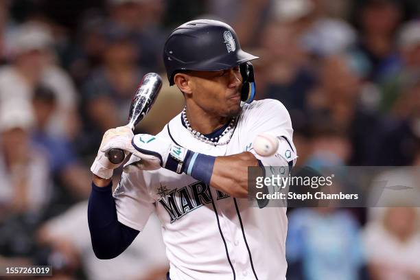 Julio Rodriguez of the Seattle Mariners is hit by a pitch during the ninth inning against the Minnesota Twins at T-Mobile Park on July 19, 2023 in...