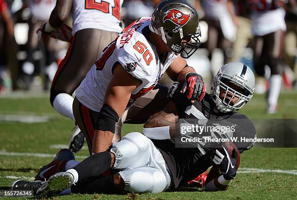 Darren McFadden of the Oakland Raiders is touched town by Daniel Te'o-Nesheim of the Tampa Bay Buccaneers during the first quarter of their NFL...