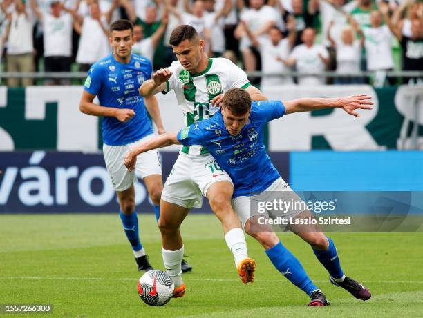 Deni Pavlovic of KI Klaksvik challenges Amer Gojak of Ferencvarosi TC during the UEFA Champions League First Qualifying Round 2nd leg match between...