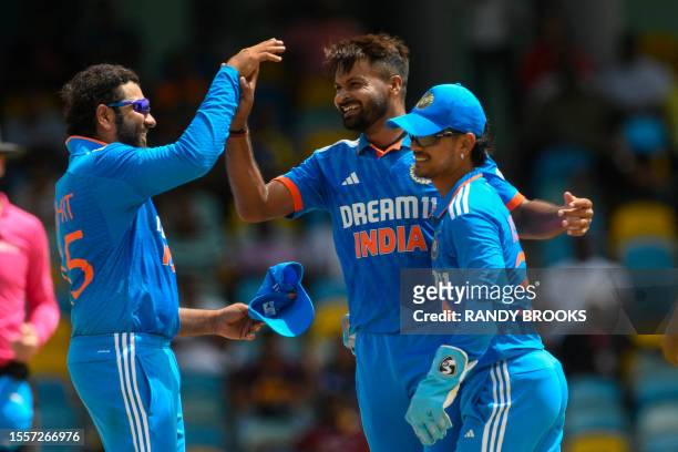 Mukesh Kumar , Rohit Sharma and Ishan Kishan of India celebrate the dismissal of Alick Athanaze of West Indies during the first One Day International...