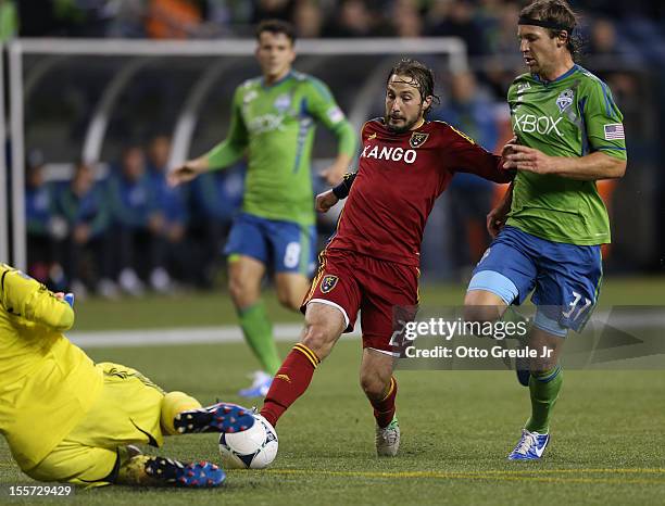 Ned Grabavoy of Real Salt Lake dribbles against Jeff Parke of the Seattle Sounders FC at CenturyLink Field on November 2, 2012 in Seattle, Washington.
