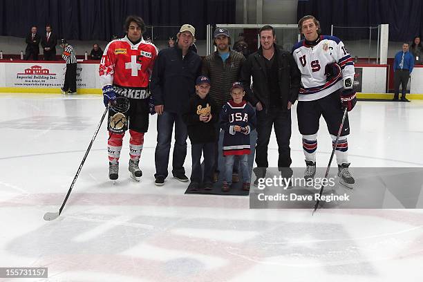 Phil Baltisberger of team Switzerland and from the Detroit Red Wings Justin Abdelkader, Patrick Eaves, Jimmy Howard and from team USA John Hayden are...