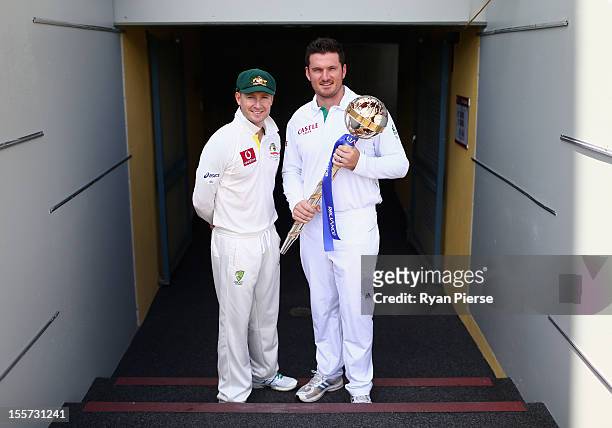 Michael Clarke of Australia and Graeme Smith of South Africa pose with the ICC Test Championship Mace during a captain's media call at The Gabba on...