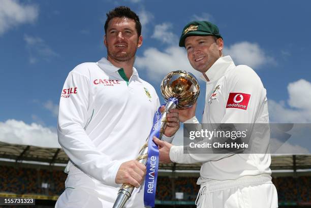 Michael Clarke of Australia and Graeme Smith of South Africa pose with the ICC Test Championship Mace during a captain's media call at The Gabba on...