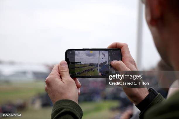 Fan takes a photo on a mobile phone looking over the 1st tee on Day One of The 151st Open at Royal Liverpool Golf Club on July 20, 2023 in Hoylake,...