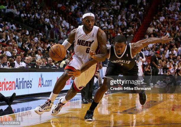 LeBron James of the Miami Heat drives on Joe Johnson of the Brooklyn Nets during a game at AmericanAirlines Arena on November 7, 2012 in Miami,...