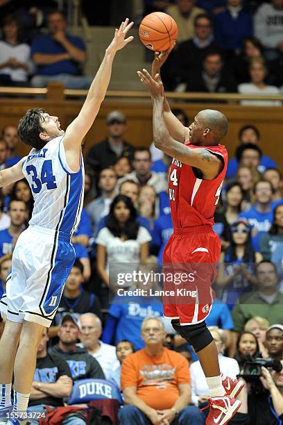 Ryan Kelly of the Duke Blue Devils blocks a shot by Wakefield Ellison of the Winston-Salem State Rams at Cameron Indoor Stadium on November 1, 2012...