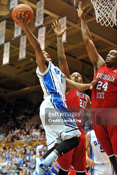 Quinn Cook of the Duke Blue Devils goes to the hoop against Stephon Platt and Kimani Hunt of the Winston-Salem State Rams at Cameron Indoor Stadium...
