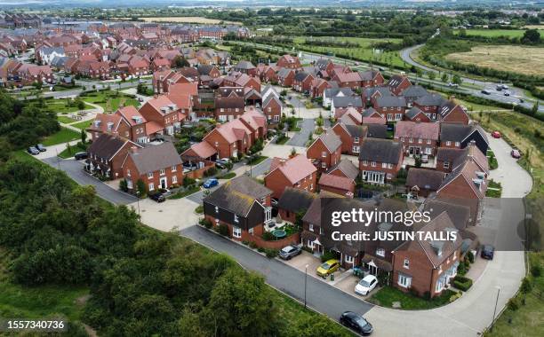 An aerial picture shows residential properties at a Barratt and David Wilson construction site for new houses and homes, near Aylesbury, on July 27,...