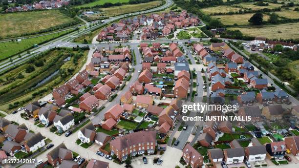 An aerial picture shows residential properties at a Barratt and David Wilson construction site for new houses and homes, near Aylesbury, on July 27,...