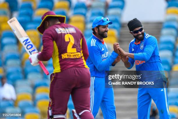 Ravindra Jadeja and Rohit Sharma of India celebrate the dismissal of Shimron Hetmyer of West Indies during during the first One Day International...