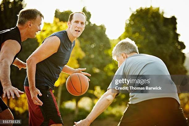 Male basketball player dribbling ball on court