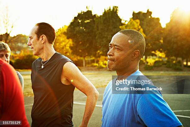 basketball player with concerned look on court - engaged sunset stockfoto's en -beelden